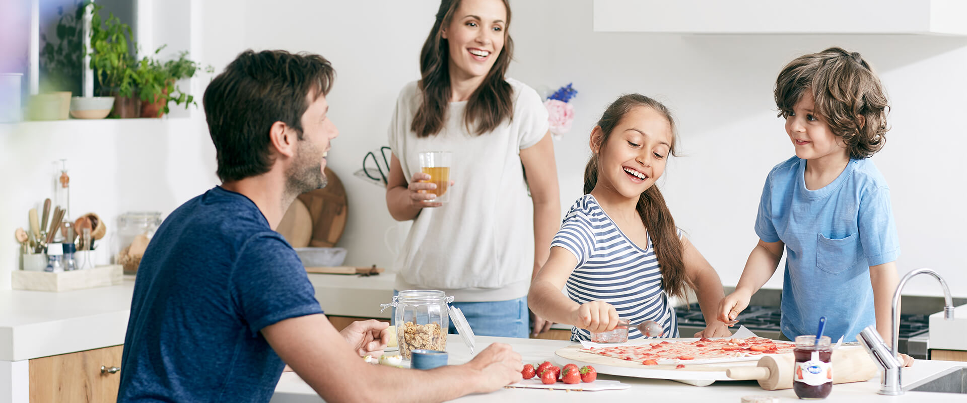 family around the table laughing and cooking together