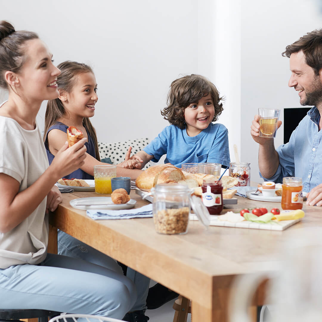family around the table making crepes